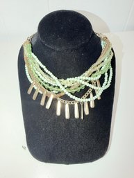 Multi Layered Necklace Featuring Various Green And White Beads As Well As Gold-toned Chains Dangling Charms