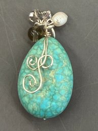 Turquoise Wire Wrapped Pendant Featuring A Coiled Wide Bail