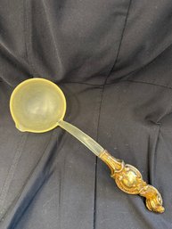 Vintage Yellow Plastic Soup Ladle With A Decorative Gold Tone Or Brass Accented Ornate Handle Closely