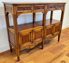 A Vintage Cabinet With Four Drawers And Doors.