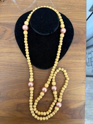 Long Single Strand Necklace Featuring Wooden Beads And Large Pink Accent Pearls