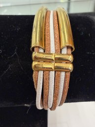 White And Gold Multi-strand Leather Cuff Bracelet Featuring Metallic Tubes And A Magnetic Clasp