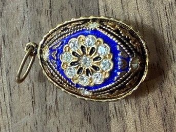 Blue Enamel Egg Pendant With A Diamond Cluster Floral Setting