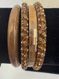 Set Of Vintage-style Gold Bangle Bracelets Featuring Etched Textures And Sparkling Rhinestone-encrusted Desgin