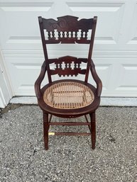 Antique Wooden Chair With Woven Cane Seat And Carved Backrest