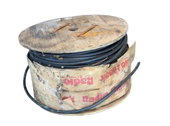 Large Wooden Spool Holding Black Electrical Or Coaxial Wire With Visible Vintage Radio Shack Packaging