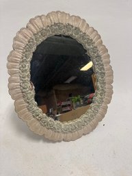 Vintage Syroco Oval Mirror With A Floral Design And Scalloped Edging
