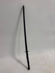 Katana, A Type Of Japanese Samurai Sword, Featuring A Traditional Black Handle Wrap Over A White Rayskin Textu