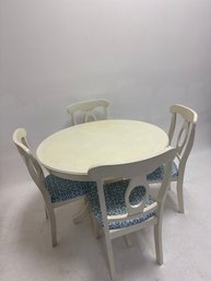 White Round Dining Table Set With Four Upholstered Chairs.