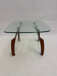Mid-century Side Table With A Clear Tempered Glass Top, Metal Tubes, And A Contemporary Style.