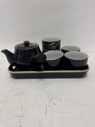 Black Japanese Tea Set Featuring A Teapot, Cups, And A Tray