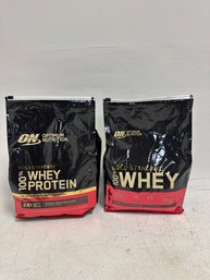 Two Bags Of Optimum Nutrition Gold Standard 100% Whey Protein Powder In Double Rich Chocolate Flavor.
