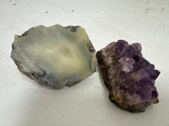 Two Natural Mineral Specimens: A Polished Agate Slice And A Raw Amethyst Crystal Cluster