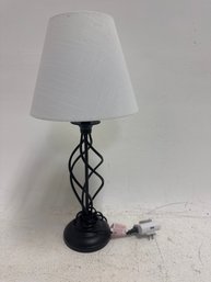 Black Metal Spiral Cage Table Lamp With A White Shade.