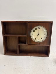A Vintage Wood Clock With Shelves