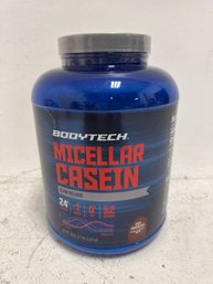 A Container Of BodyTech Micellar Casein Protein Powder In Rich Chocolate Flavor.