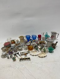 A Collection Of Assorted Miniature Collectible Items, Primarily Tiny Tea Cups, Saucers, And Figurines