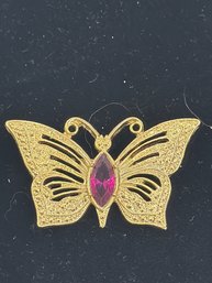 Vintage Gold-tone Butterfly Brooch Featuring A Pink Rhinestone Center And Textured Wings