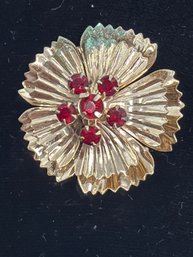 Vintage Floral Brooch Featuring Fluted Gold-toned Petals And A Central Cluster Of Red Glass