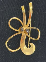 Vintage Gold Tone Floral Brooch Featuring A Loop Design And Two Dark Stones