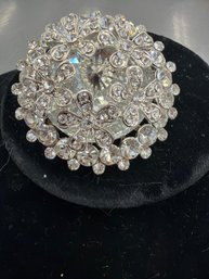 Vintage Rhinestone Circle Brooch Featuring A Silver-tone Metal Frame And Floral Designs