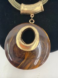 Skye Brown Marbled Round Pendant Multi Strand Cord Necklace Featuring A Large Polished Brown Pendant