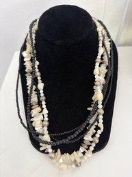 Multi Strand Beaded Statement Necklace Featuring Natural White Chips And Dark Beads