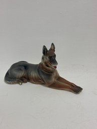 Vintage Porcelain Figurine Depicting A German Shepherd Dog In A Lying Position