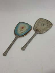 Features Two Vintage Handheld Vanity Mirrors From A Set, Likely From The 1920s To 1940s, Showcasing Classic Ar