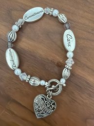 Volunteer Heart Charm Bracelet Features Silver-toned Beads And Engraved Words Such As 'care' 'dedication' Etc