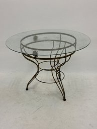 Vintage Italian-style Wrought Iron Dining Table With A Round Glass Top, Often Featuring Artistic Sun-shaped De