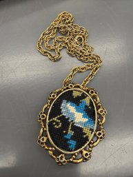 Vintage Needlepoint Brooch Pendant Featuring An Embroidered Bird Design Within A Filigree Frame