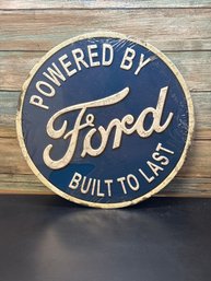 Vintage-style Ford 'Powered By Ford Built To Last' Embossed Metal Sign.