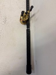 Fishing Rod And Reel Combo, Specifically A Shimano Calcutta 400 Baitcasting Reel Attached To A Fishing Rod.