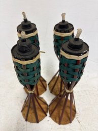 Four Bamboo Tabletop Tiki Torches, Often Used For Outdoor Lighting And Decor During Events Like Garden Parties