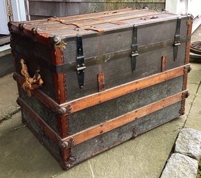 Antique Trunk With Wooden Trim And Metal Closures