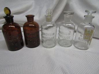 4 EMBOSSED CHEMICAL BOTTLES
