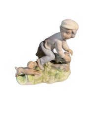 Porcelain Sculpture Of Kid And Dog Playing