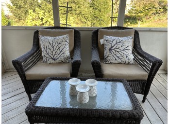Pair Of Outdoor Chairs With Seat Cushions, Throw Pillows, And Matching Glass And Wicker Table (Also Includes 3 White Candleholders)