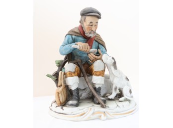 Hand-Painted Porcelain Figurine Of Seated Man With Dog