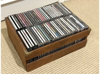 Large Collection Of Music CDs In A Wooden Storage Crate