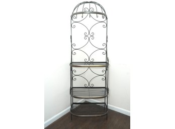 Tall Wrought Iron Bakers Rack With Ornate Scrollwork And Three Shelves