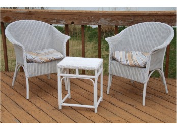 A Matching Pair Of Wicker Side Chairs With Matching Table
