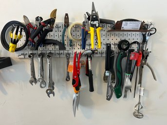 Assorted Hand Tool Collection On Pegboard With Wrenches, Pliers, & Gardening Tools
