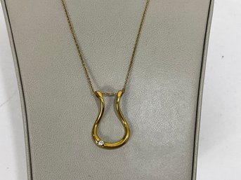 Emily C Ring Holding Necklace