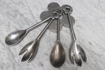 Collection Of Serving Utensils With Trivet