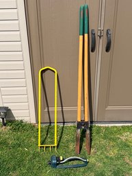 Collection Of Outdoor Tools And Sprinkler