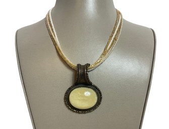 Four Strand Beaded Necklace With Oval Pendant And Earrings