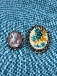 Two Cameo Brooches, Pendant With Yellow & Blue Floral Spray, Woman With Shield And Torch, Gold Toned Frames