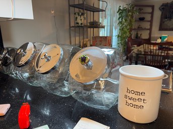 Five Glass Canisters And A CrocK